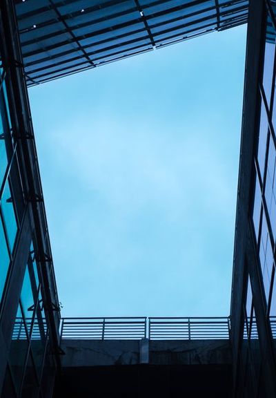 A striking view of contemporary architecture framing a serene blue sky.